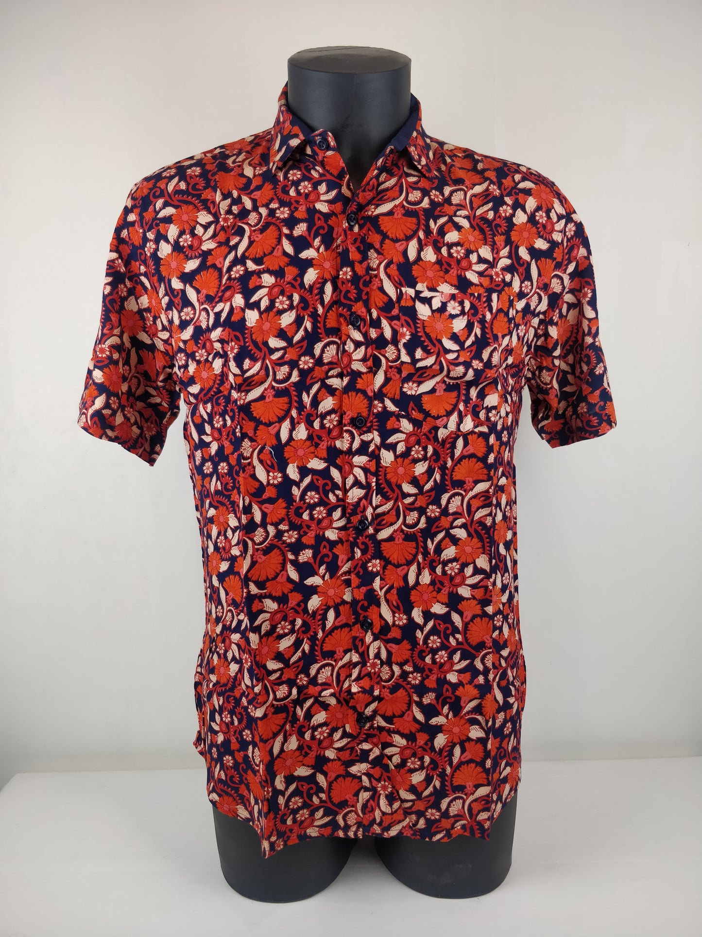 Chemise homme Ribhu manches courtes. Chemise décontractée souple en rayonne. Motif fleuri orange et bleu.