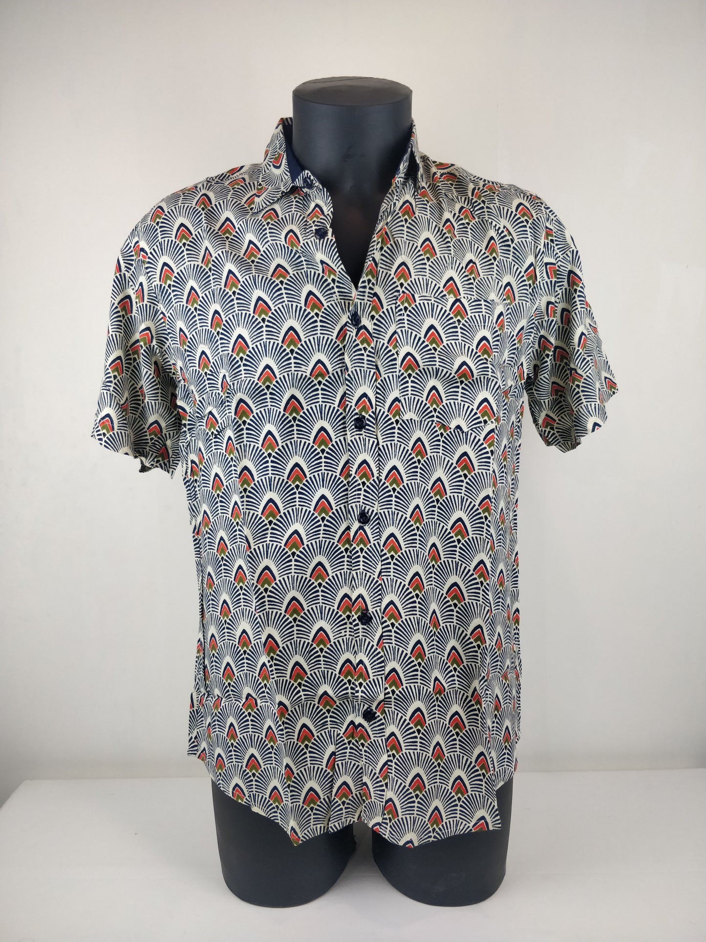 Chemise homme Ribhu manches courtes. Chemise décontractée souple en rayonne. Motifs géométriques blanc, bleu et orange.