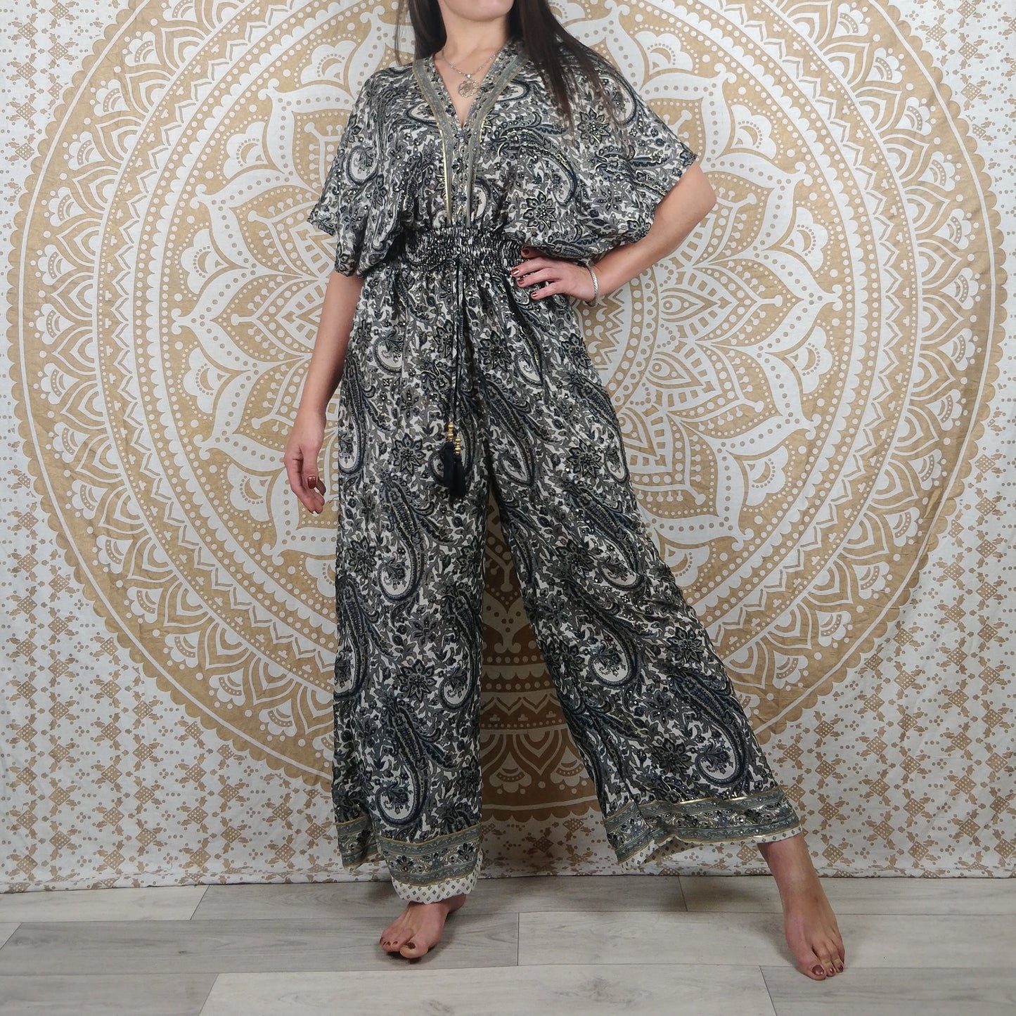 Combinaison femme Jalley en soie indienne. Combi ajustée avec jambes larges et manches courtes. Imprimé paisley gris, noir et blanc avec insertions or.