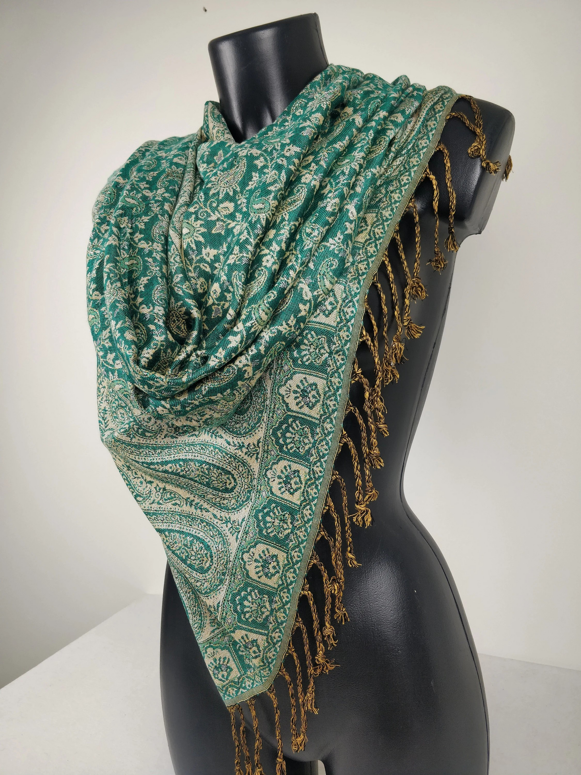 Écharpe pashmina élégante avec motifs paisley verts et blancs, fabriquée en viscose réversible.